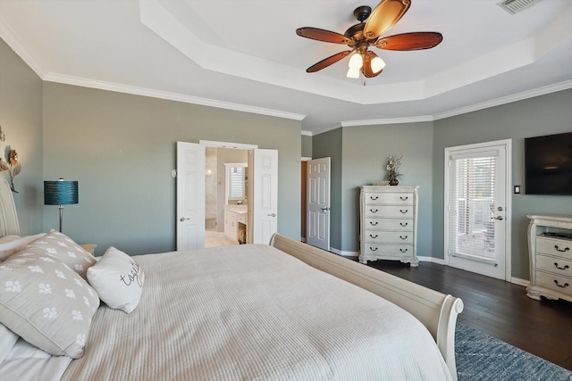 bedroom featuring baseboards, ensuite bathroom, access to outside, a raised ceiling, and wood-type flooring