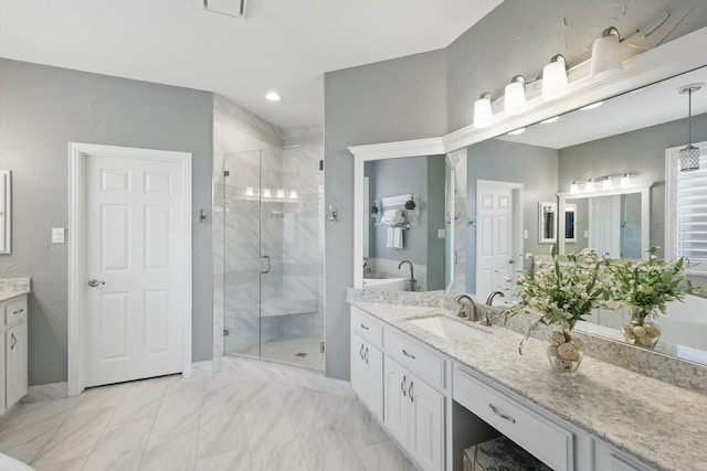 full bathroom featuring marble finish floor, two vanities, a sink, recessed lighting, and a shower stall