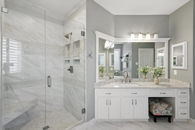 bathroom with vanity, a shower stall, and marble finish floor