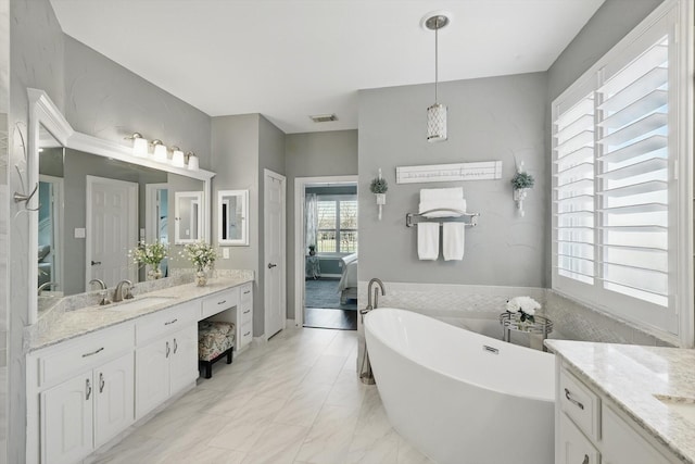 full bath with visible vents, ensuite bathroom, a soaking tub, marble finish floor, and vanity