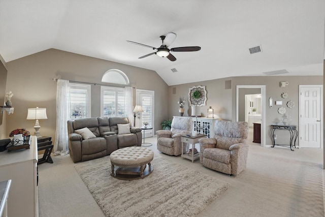 carpeted living area with visible vents, ceiling fan, and vaulted ceiling