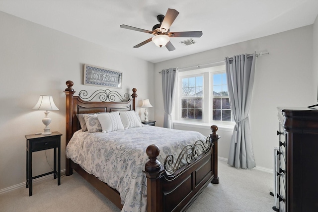 bedroom featuring ceiling fan, light colored carpet, visible vents, and baseboards