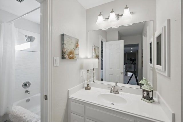 bathroom with shower / tub combo with curtain and vanity