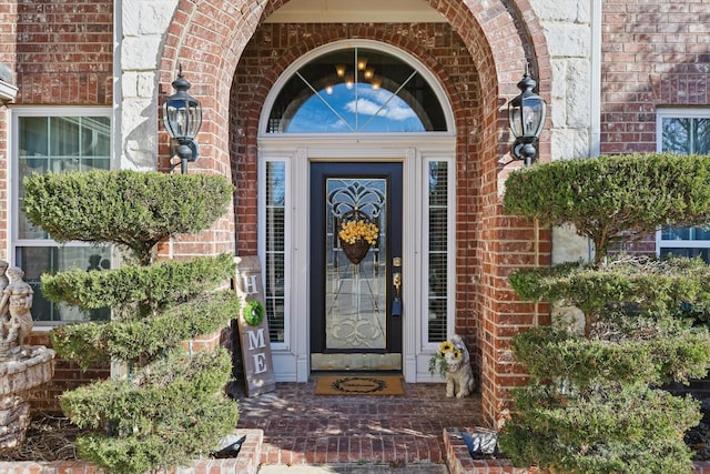 property entrance featuring brick siding