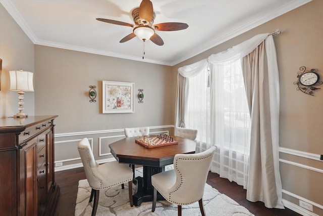 dining space featuring ceiling fan, a healthy amount of sunlight, dark wood-style floors, and crown molding