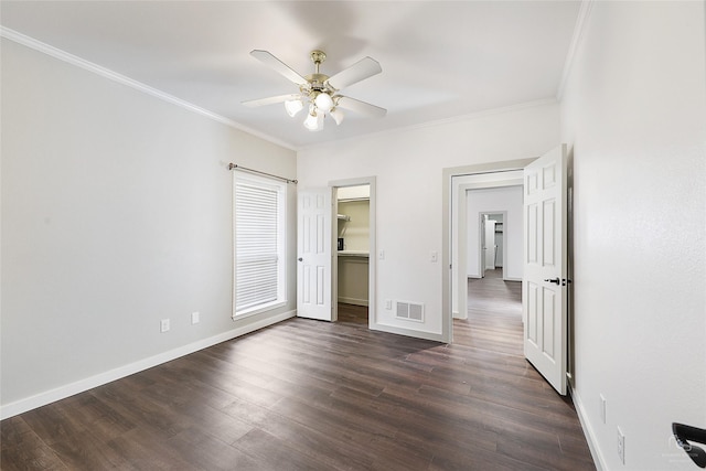 unfurnished bedroom featuring dark wood finished floors, crown molding, and baseboards