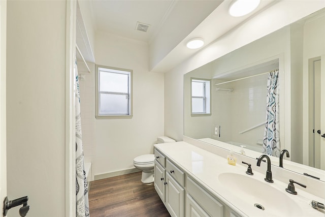 full bathroom featuring visible vents, toilet, wood finished floors, crown molding, and vanity