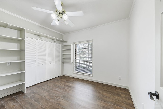 unfurnished bedroom featuring a closet, baseboards, dark wood-type flooring, and ornamental molding