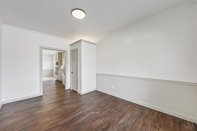 unfurnished room with crown molding, baseboards, and dark wood-style flooring