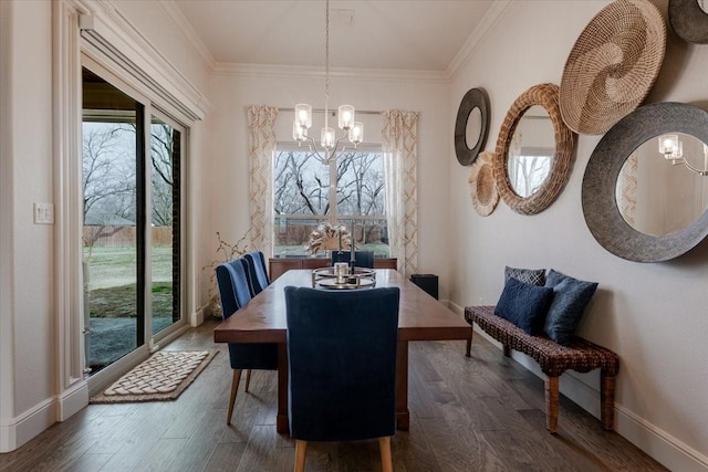 dining area with a notable chandelier, a healthy amount of sunlight, crown molding, and wood finished floors