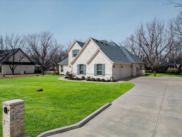 view of front of property featuring a shingled roof, a front lawn, concrete driveway, a garage, and brick siding