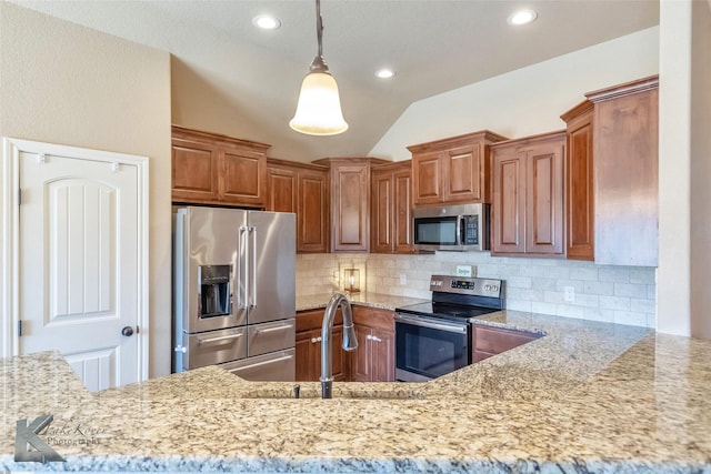 kitchen featuring a sink, decorative backsplash, light stone counters, and appliances with stainless steel finishes