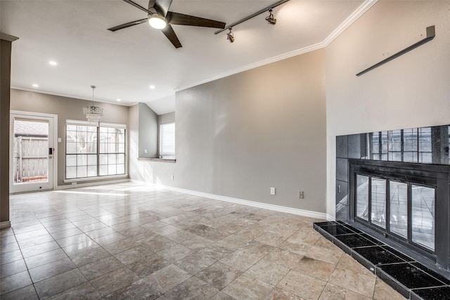 unfurnished living room with ceiling fan with notable chandelier, recessed lighting, a fireplace, crown molding, and baseboards