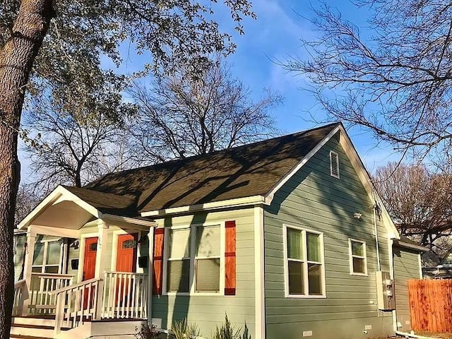 view of front of home featuring fence and crawl space