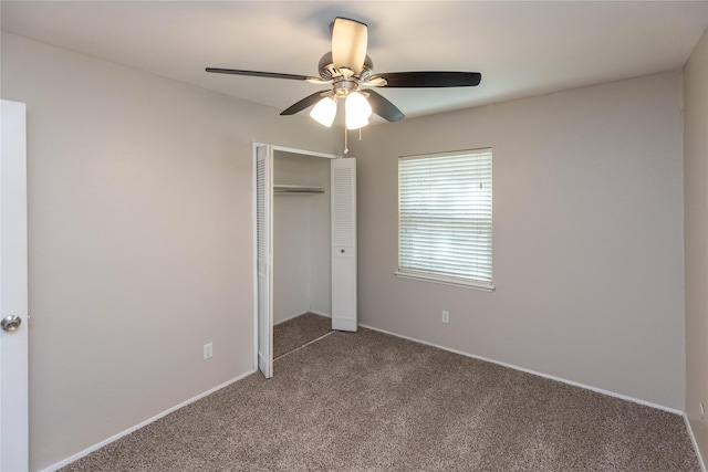 unfurnished bedroom featuring a closet, a ceiling fan, and carpet