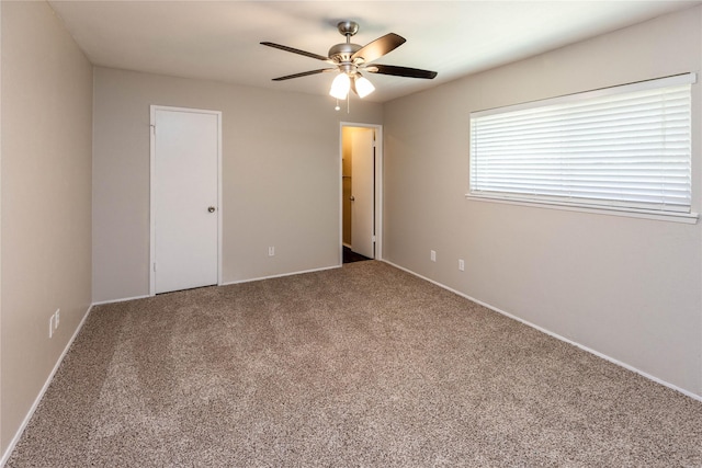 unfurnished bedroom with a ceiling fan, baseboards, and carpet floors