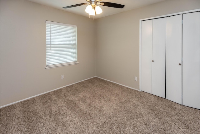 unfurnished bedroom with a ceiling fan, a closet, and carpet floors