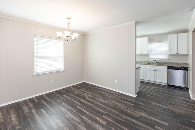 unfurnished dining area with a sink, crown molding, dark wood-style floors, and a chandelier