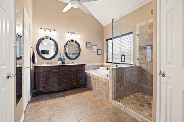 full bathroom with a sink, a shower stall, double vanity, lofted ceiling, and a bath