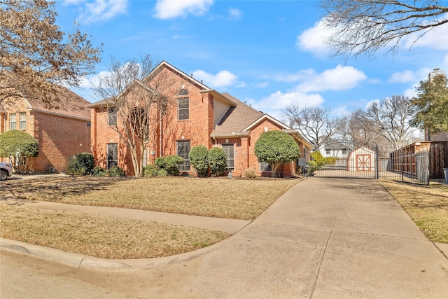 traditional-style house featuring fence, brick siding, concrete driveway, and a gate