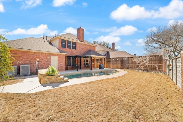 back of house featuring a patio area, cooling unit, brick siding, and a fenced backyard