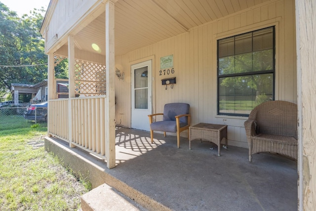 view of patio / terrace with fence and covered porch