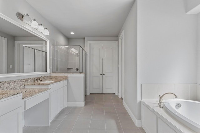 full bath featuring vanity, baseboards, a stall shower, tile patterned flooring, and a bath