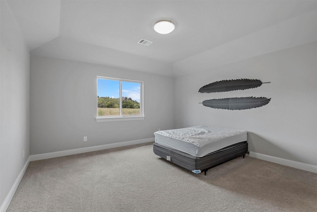 carpeted bedroom featuring baseboards and visible vents