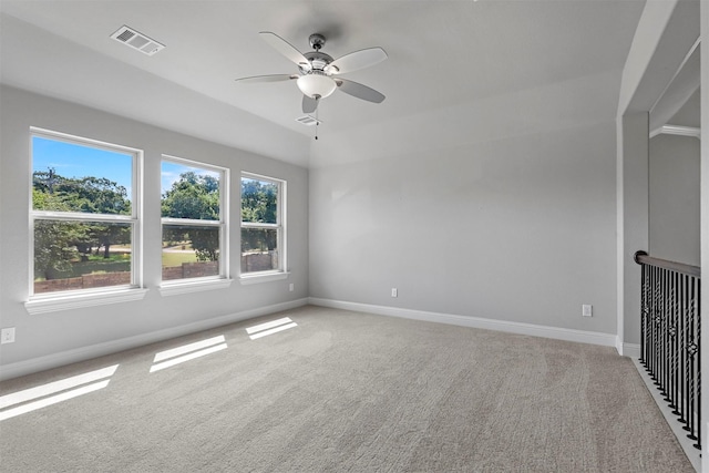 unfurnished room with visible vents, carpet flooring, a ceiling fan, and baseboards