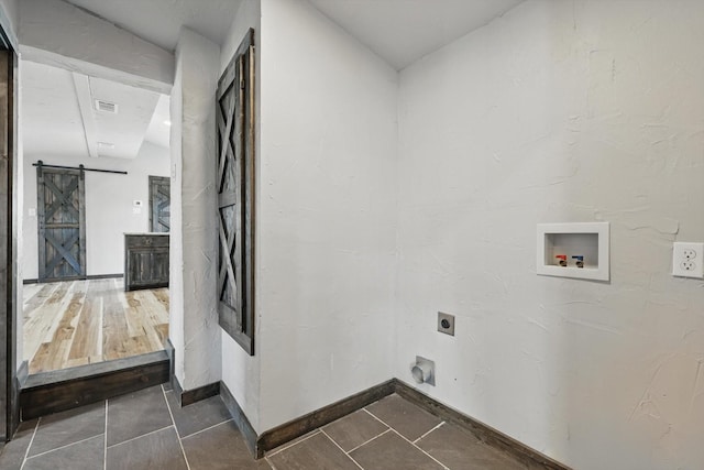 washroom with hookup for a washing machine, visible vents, laundry area, electric dryer hookup, and a barn door