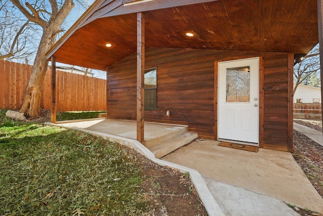 doorway to property with a patio area and fence