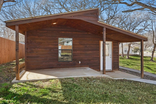 view of outbuilding featuring fence