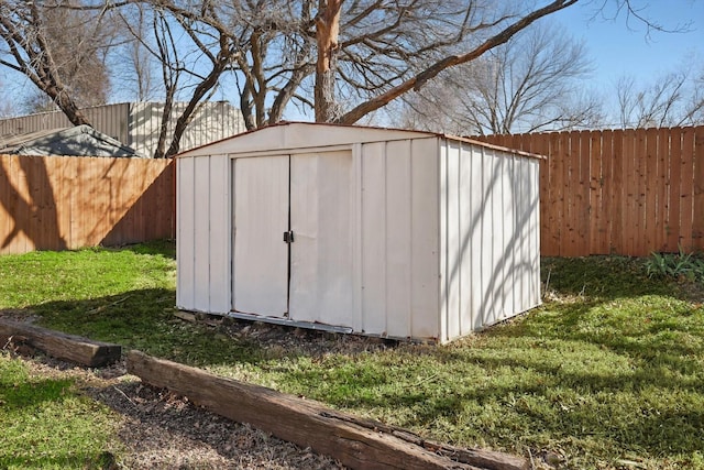 view of shed with a fenced backyard