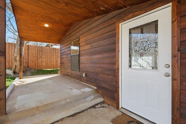 entrance to property featuring fence