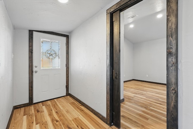 entryway featuring light wood finished floors and baseboards