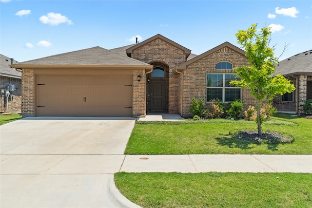 view of front of house featuring driveway, roof with shingles, an attached garage, a front lawn, and brick siding