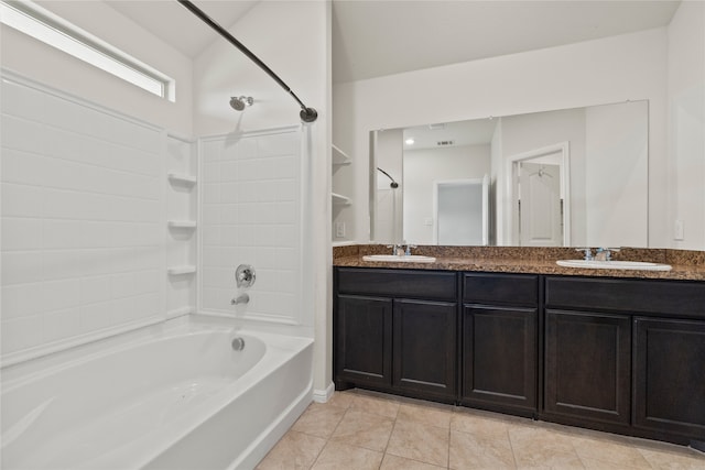 bathroom with tile patterned floors, shower / washtub combination, double vanity, and a sink