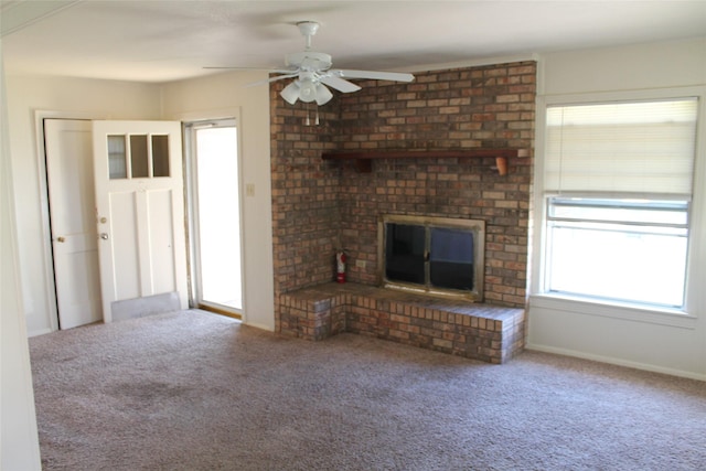 unfurnished living room featuring carpet flooring, a fireplace, baseboards, and ceiling fan