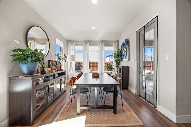 dining room with dark wood finished floors, recessed lighting, and baseboards