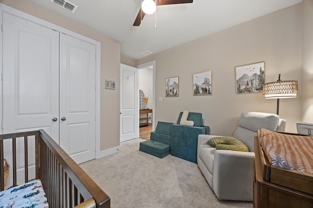 interior space featuring a closet, visible vents, and carpet