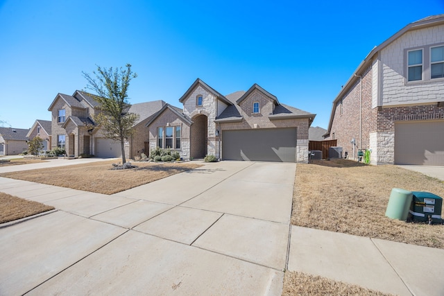 view of front of house with central air condition unit, brick siding, stone siding, and driveway