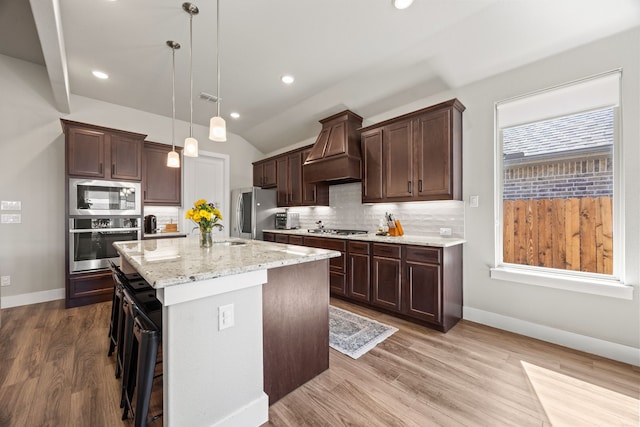 kitchen featuring custom exhaust hood, backsplash, visible vents, and appliances with stainless steel finishes