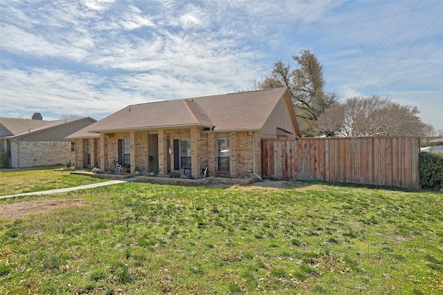 exterior space with brick siding and a front yard