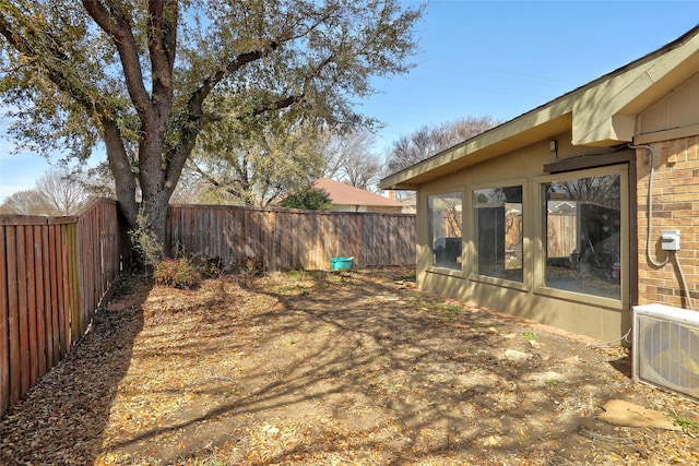 view of yard with a fenced backyard and ac unit