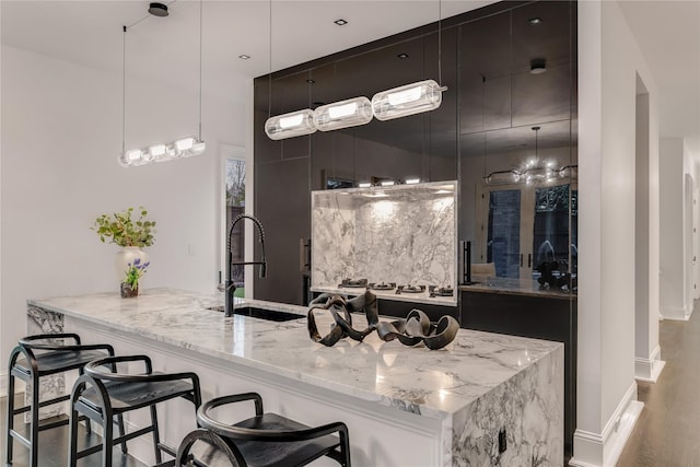 bathroom featuring a sink, baseboards, and wood finished floors