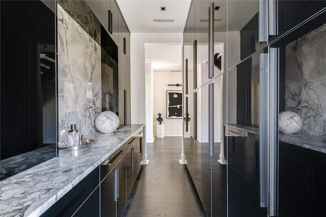6404 Lakehurst Ave, Dallas, TX 75230 - kitchen with modern cabinets, light stone countertops, and dark cabinetry