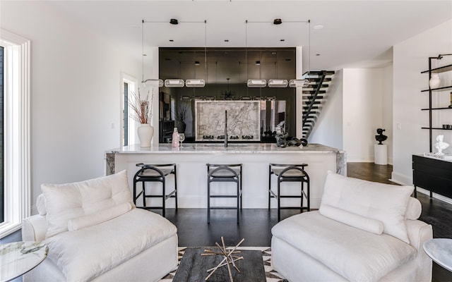 6404 Lakehurst Ave, Dallas, TX 75230 - living room featuring stairway, wood finished floors, and baseboards