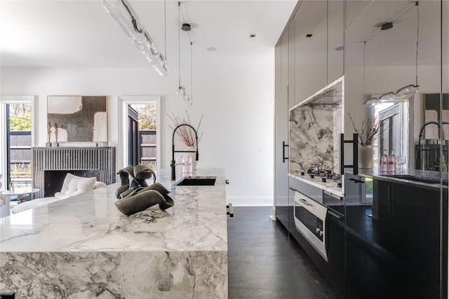 6404 Lakehurst Ave, Dallas, TX 75230 - kitchen featuring a sink, healthy amount of natural light, dark wood-style floors, and stainless steel cooktop