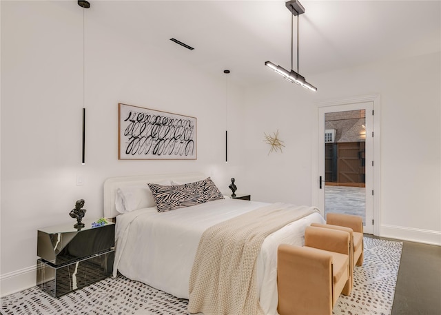 bedroom featuring visible vents, light wood-style flooring, and baseboards