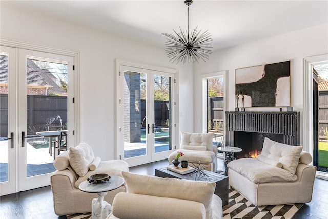 6404 Lakehurst Ave, Dallas, TX 75230 - living area featuring french doors, wood finished floors, and healthy amount of natural light